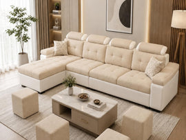 A modern sectional sofa in cream and white, styled in a contemporary living room with matching ottomans, a marble-top coffee table, and a neutral-toned rug.